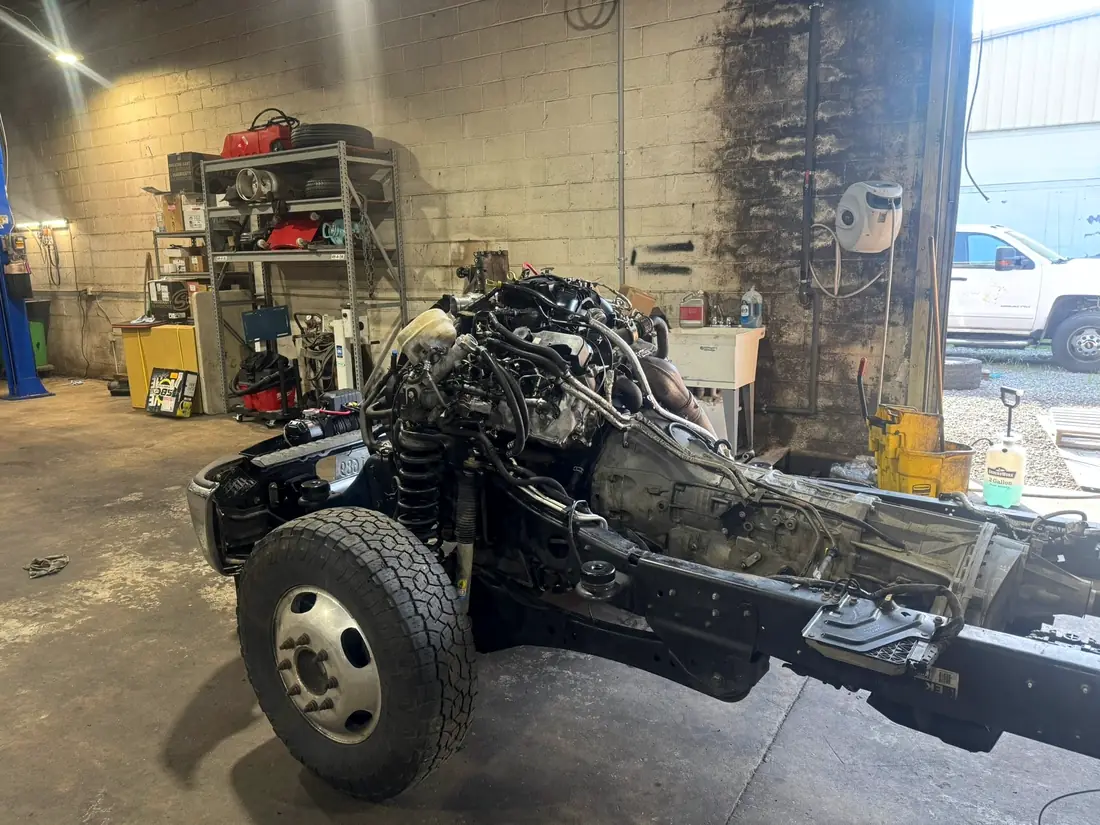 Bare truck chassis with the cab and bed removed for engine access