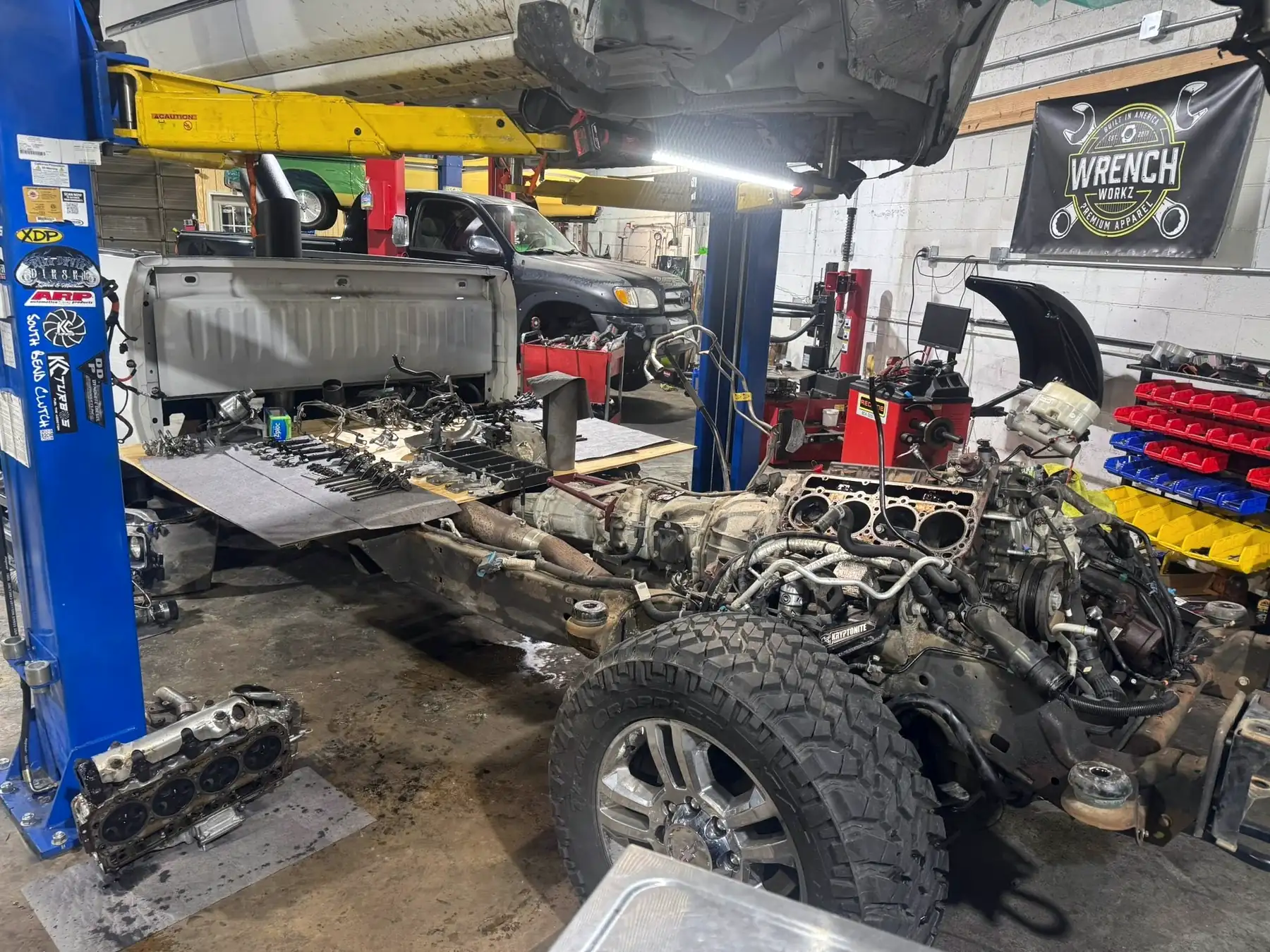 Truck chassis with the bed removed and cylinder heads off the engine