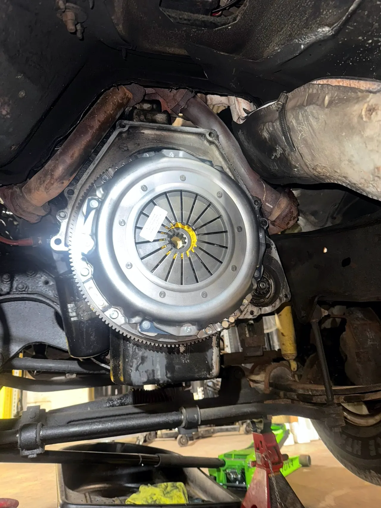 Clutch and flywheel seen from underneath a raised diesel truck