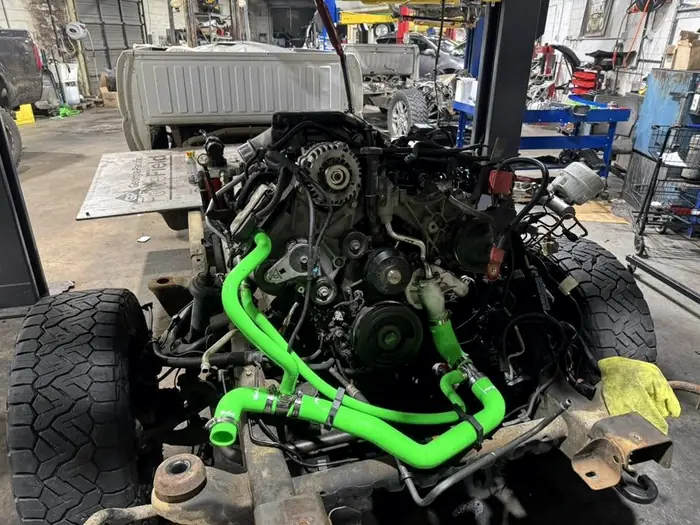 Diesel engine out of the truck with a green silicone coolant hose kit fitted
