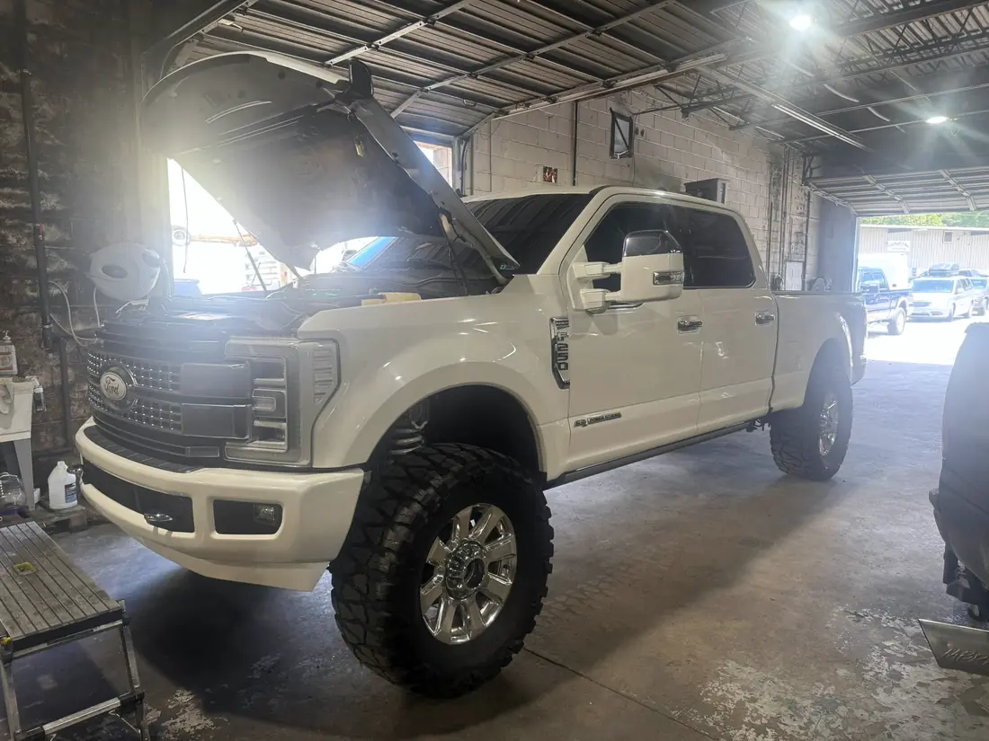 White Ford F-250 Platinum on aftermarket wheels, finished and ready for collection