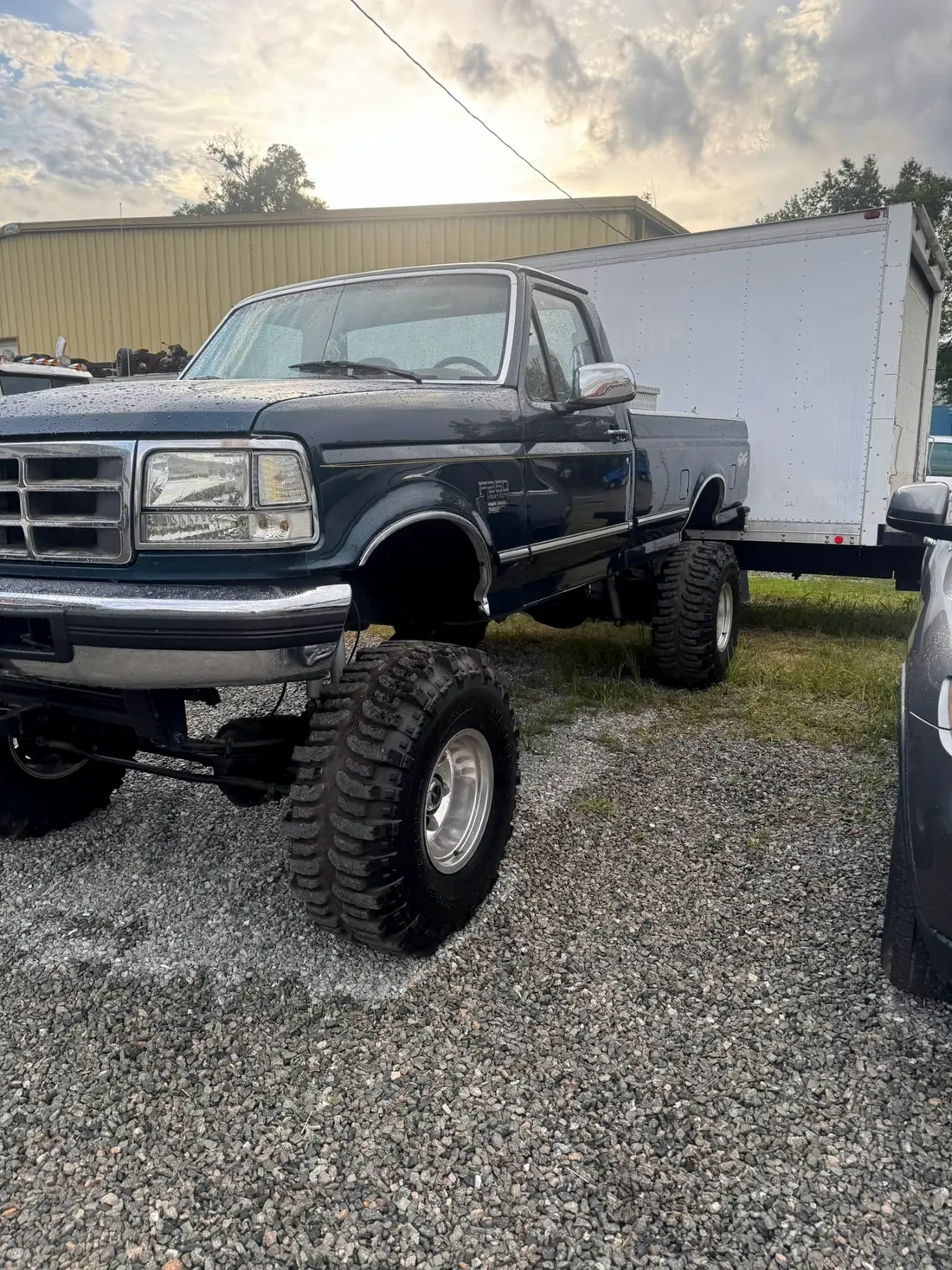 Lifted OBS Ford F-250 outside the shop