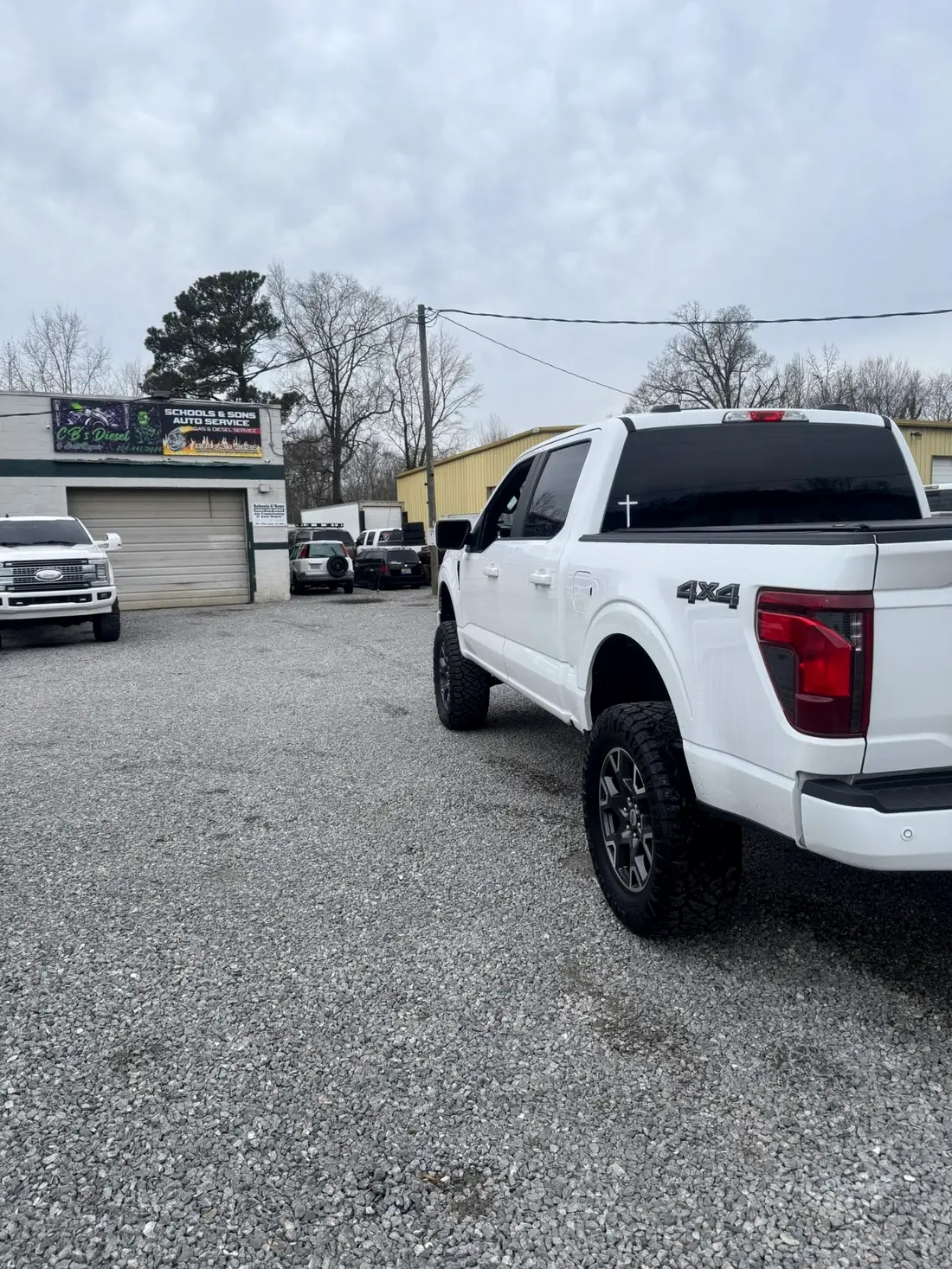 White Nissan Titan XD parked outside CBS Diesel