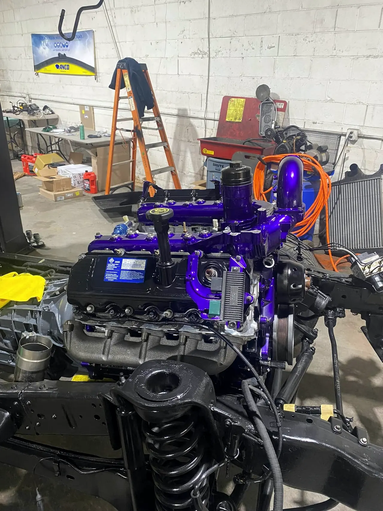 Finished 6.0 Power Stroke build sitting on the bare chassis, valve covers and intake powder-coated purple