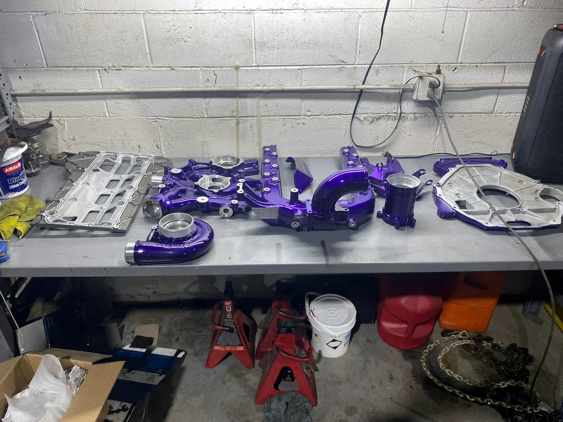Powder-coated turbocharger, intake and oil cooler components laid out on the bench for a 6.0 Power Stroke build