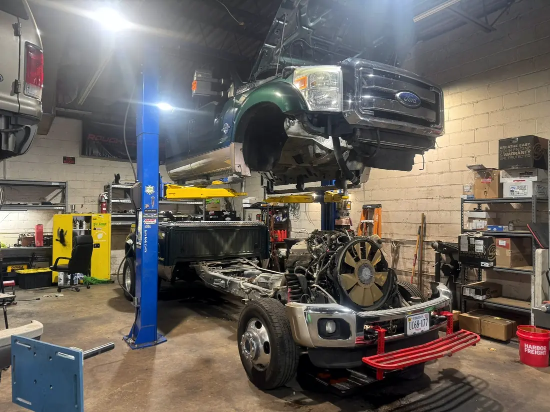 Diesel engine on a cart in front of a cab-off Ford Super Duty chassis