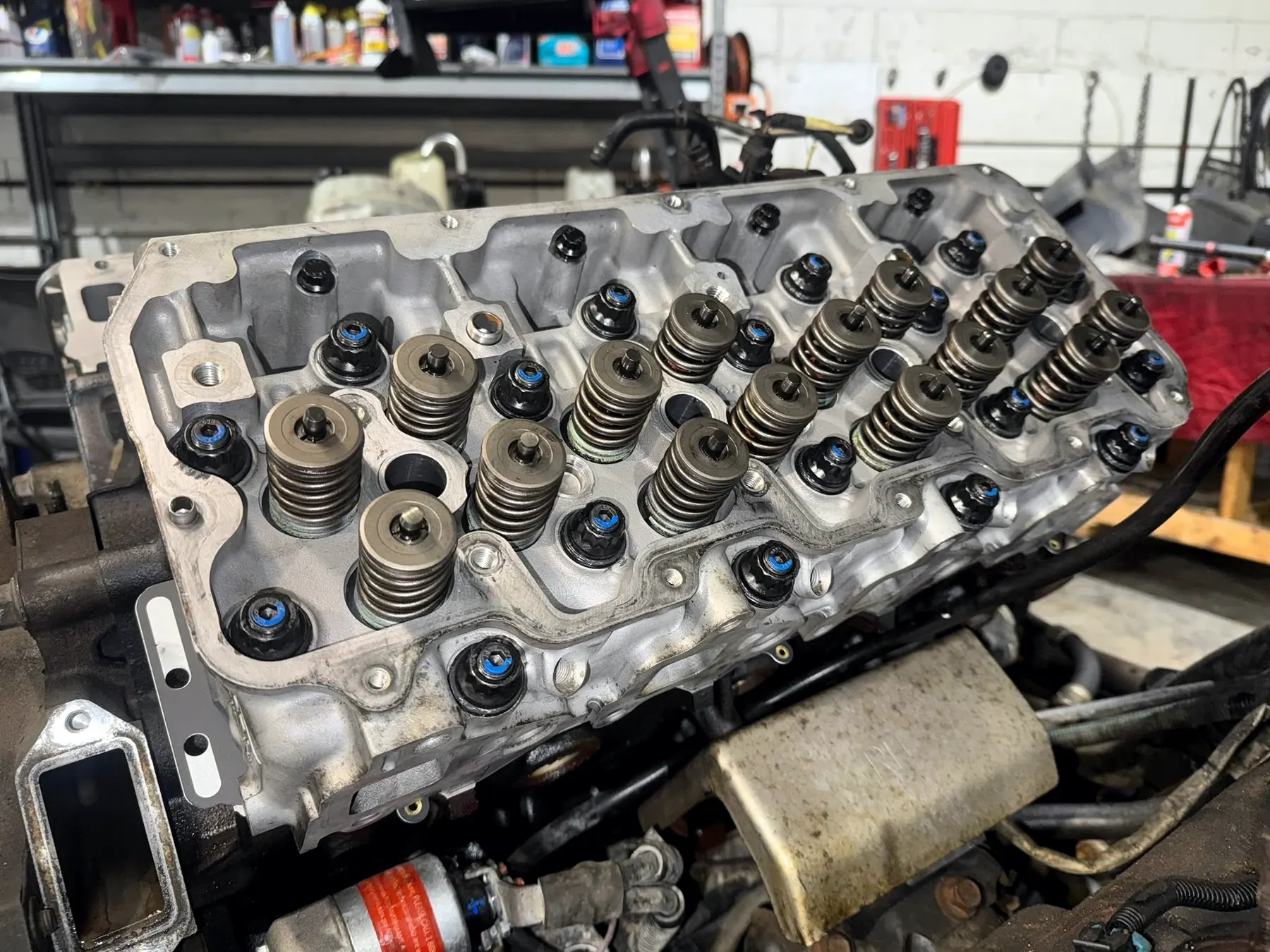 Diesel cylinder head with valve springs fitted, on the bench
