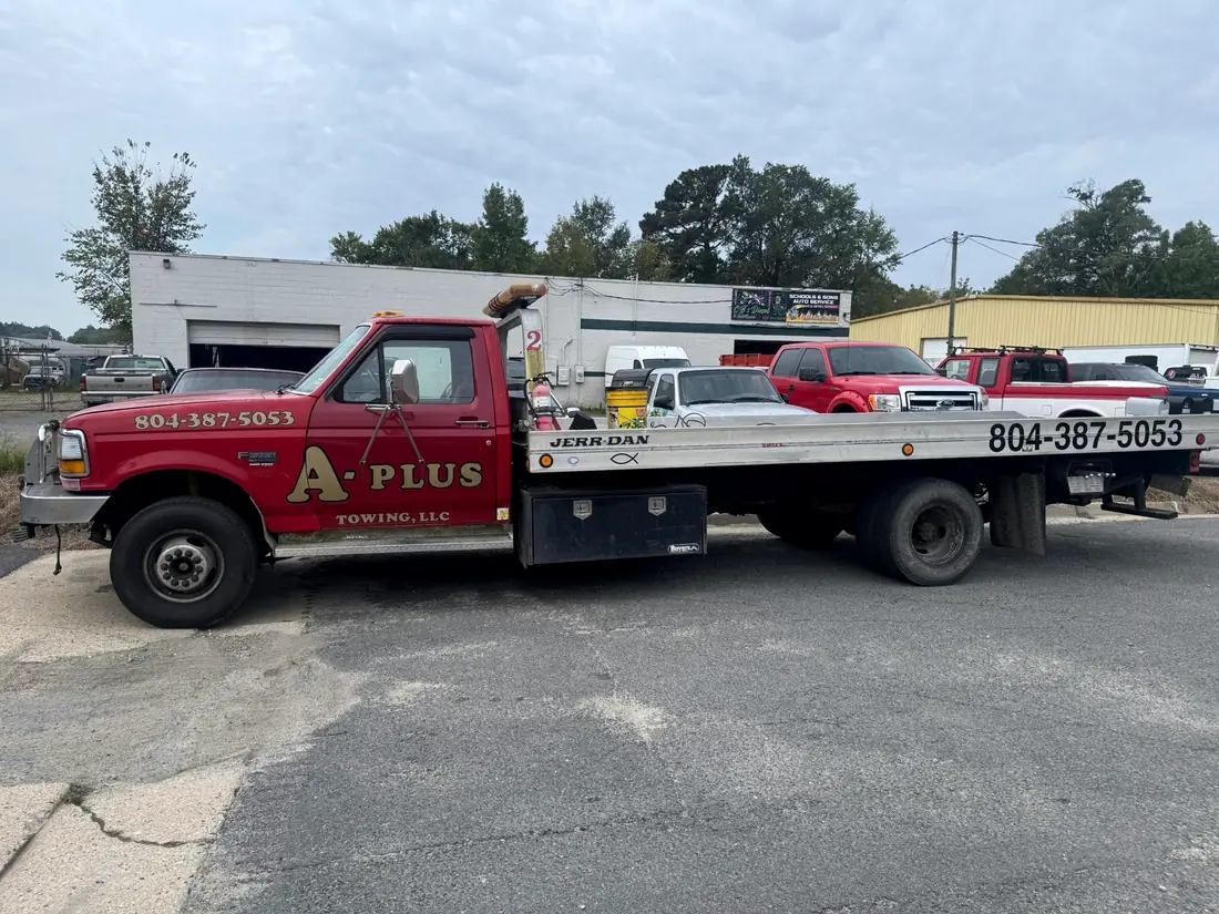 A-Plus Towing flatbed wrecker parked outside CBS Diesel
