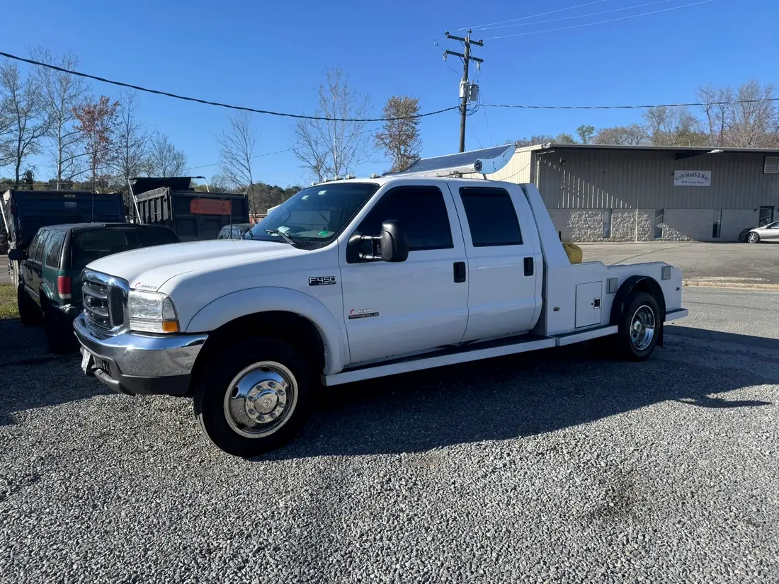 White Ford F-550 crew cab hauler outside the shop