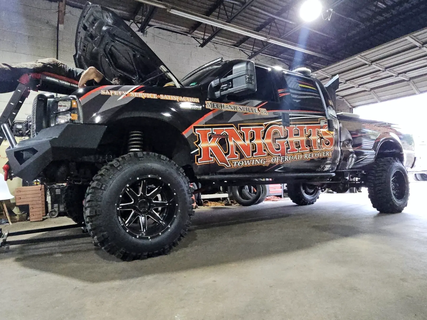 Knights Towing wrapped Ford Super Duty inside the CBS Diesel shop