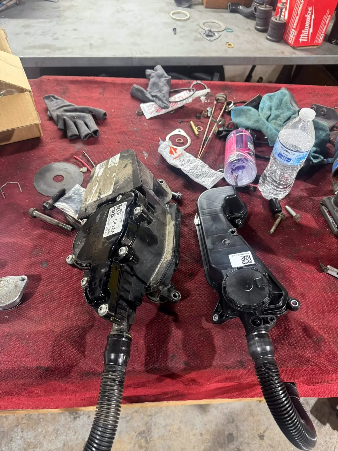 Crankcase ventilation separators removed from a diesel engine on the workbench