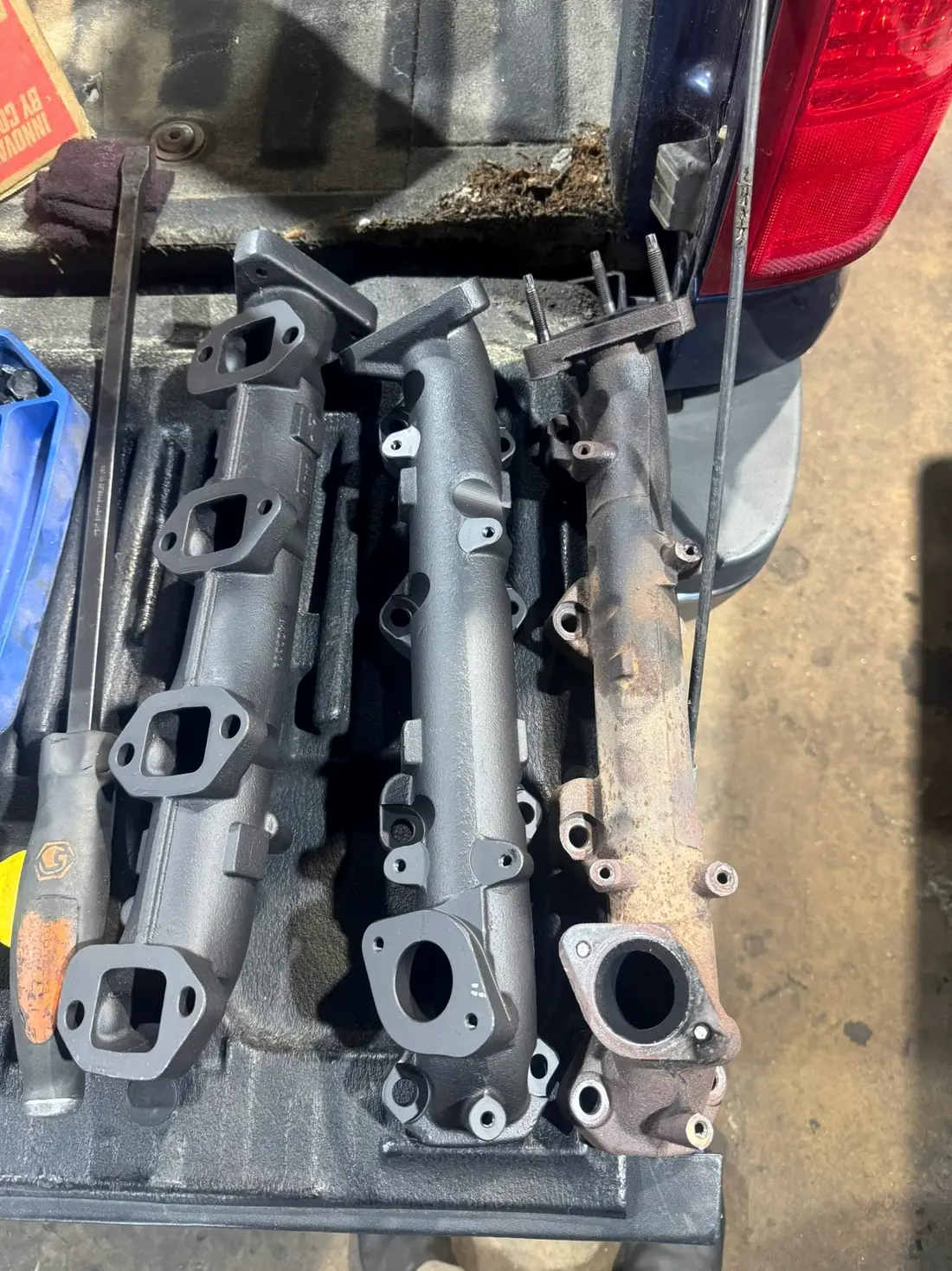 Intake and exhaust manifolds cleaned and laid out on the bench