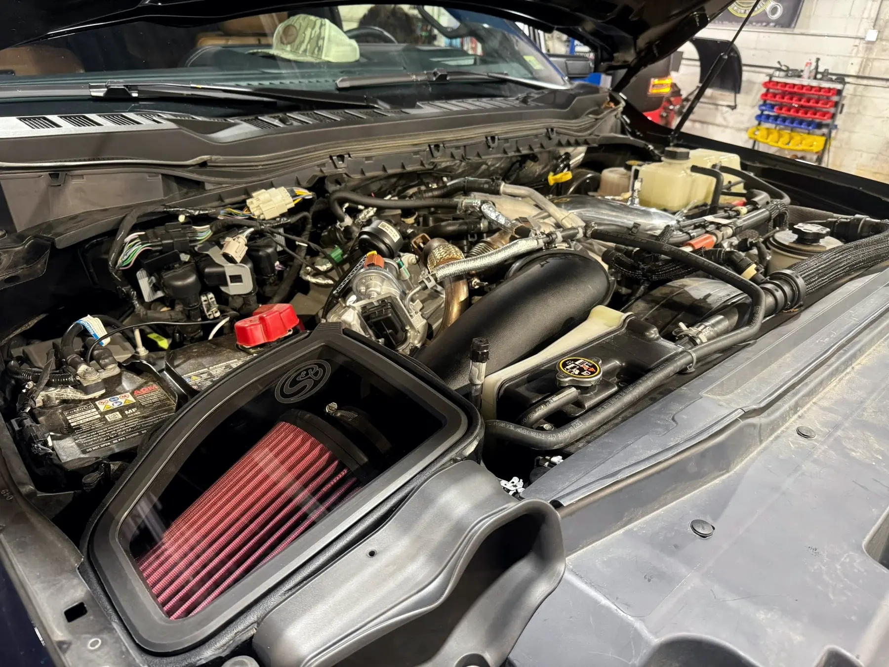 6.7 Power Stroke engine bay with an aftermarket cold air intake fitted