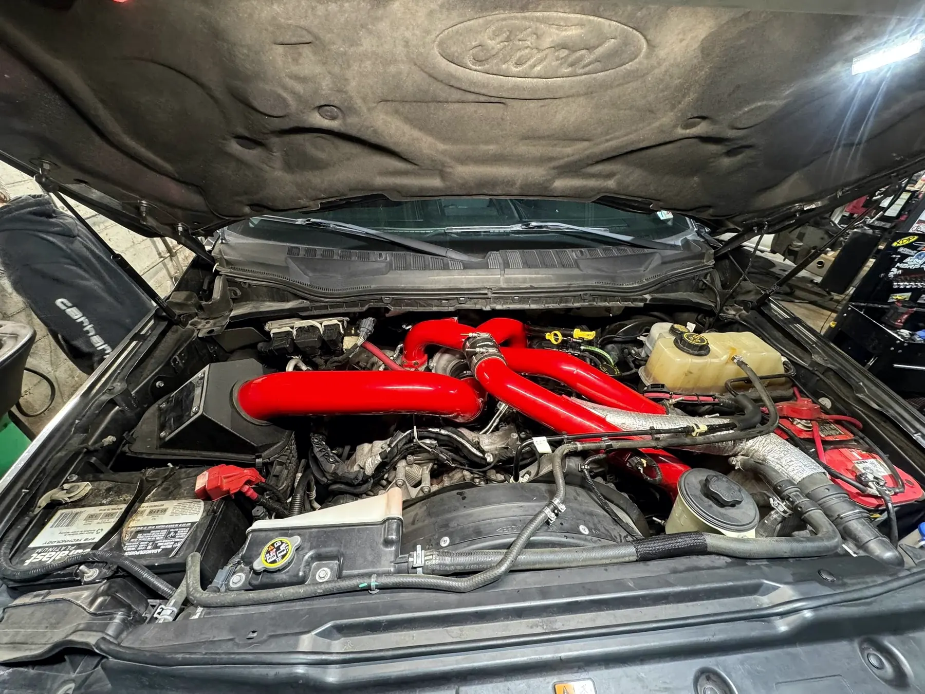 Power Stroke engine bay with red intercooler pipework
