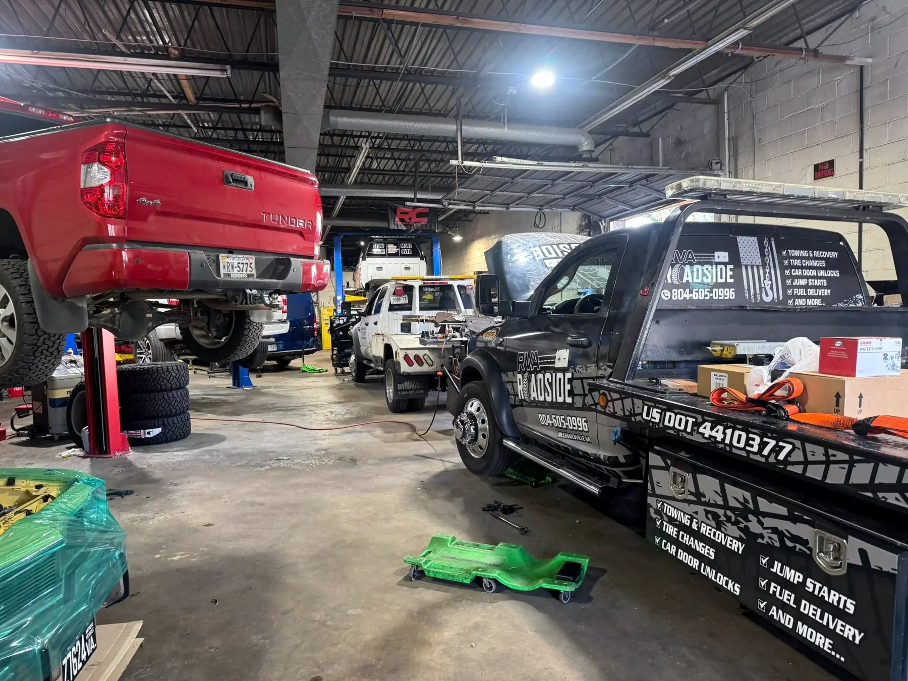 CBS Diesel shop floor at night with a red pickup on the lift