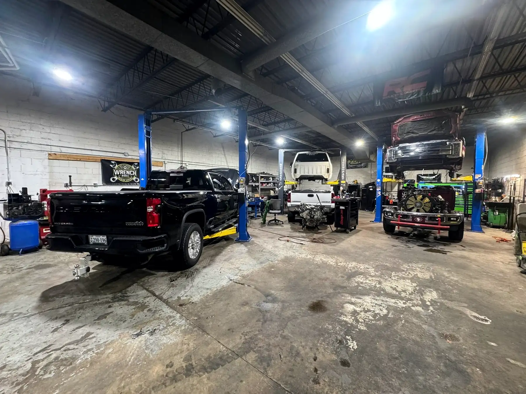Three service bays at CBS Diesel with diesel pickups on two-post lifts