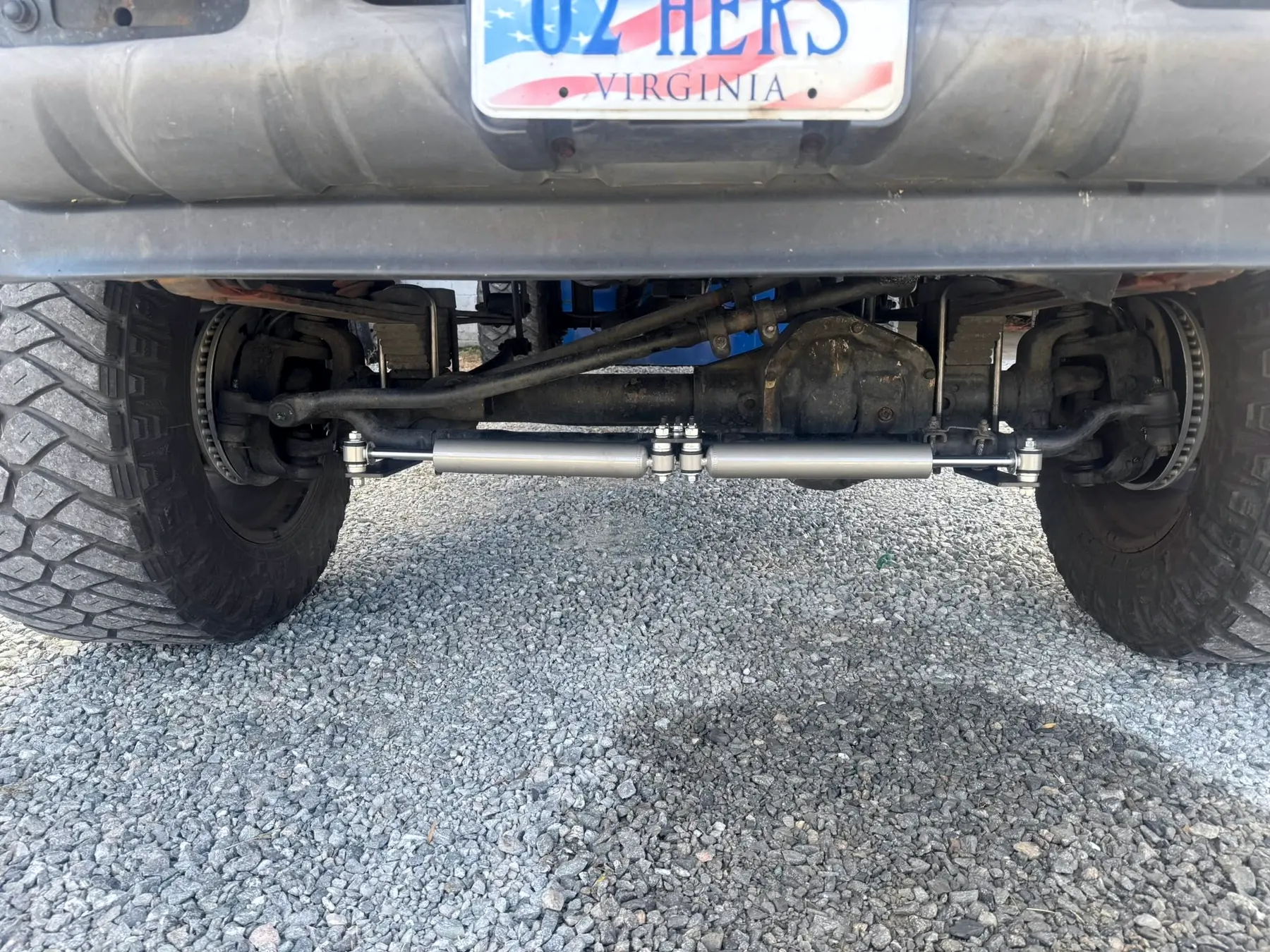 Front axle, track bar and steering linkage under a lifted truck