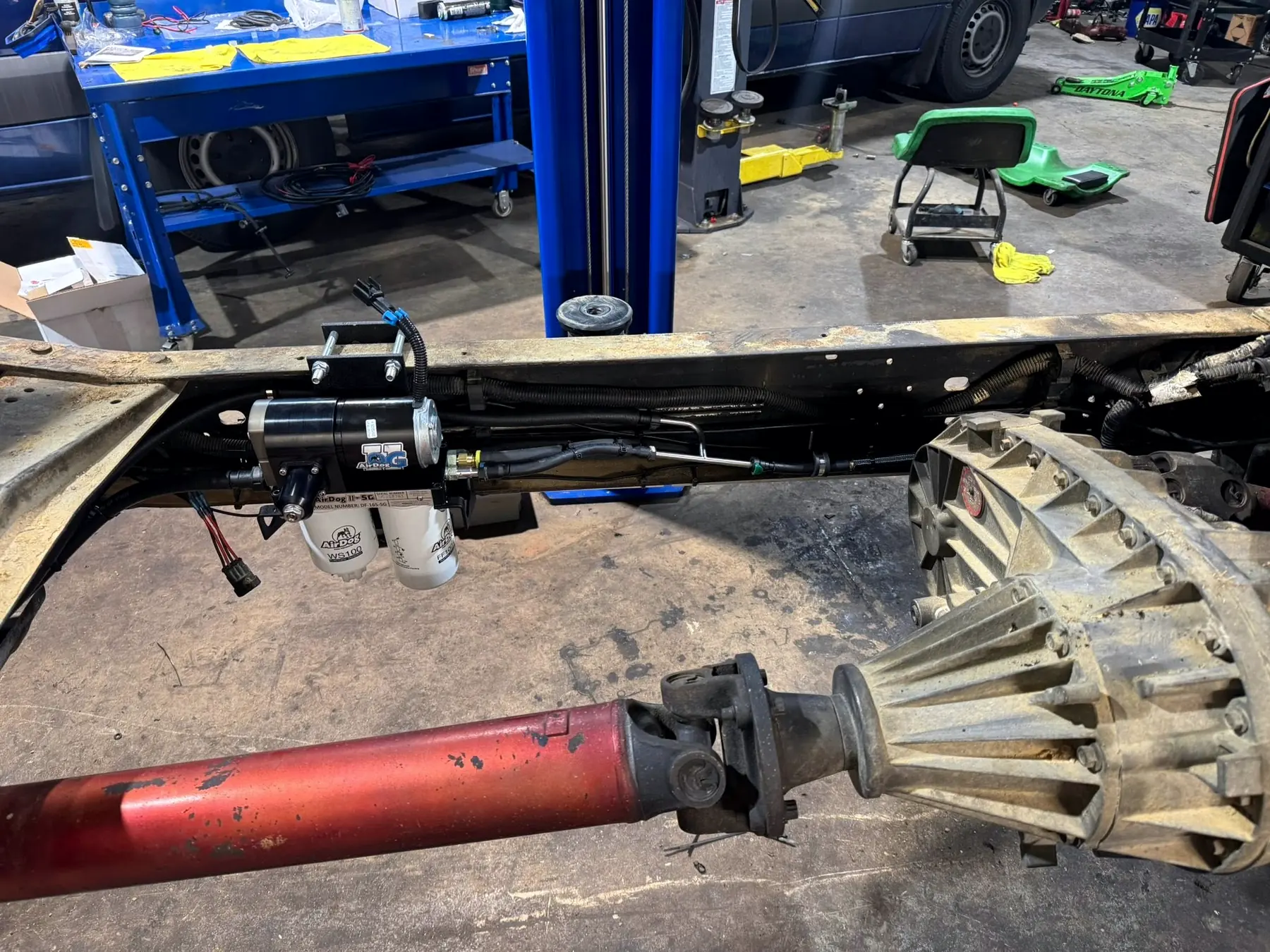Transmission and driveshaft seen from under a lifted truck