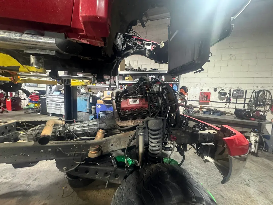 Cab-off chassis with the engine exposed during a major repair