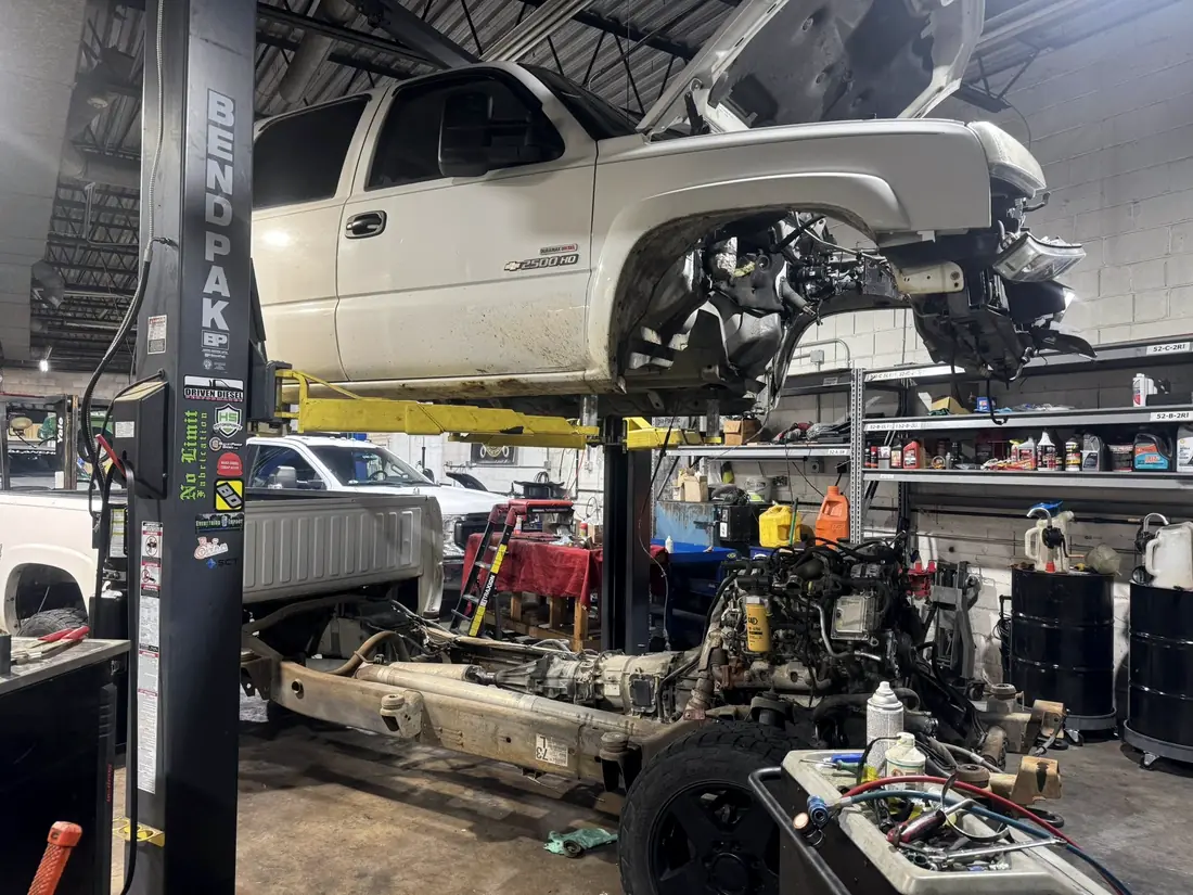 Tan Silverado on the lift with the cab removed
