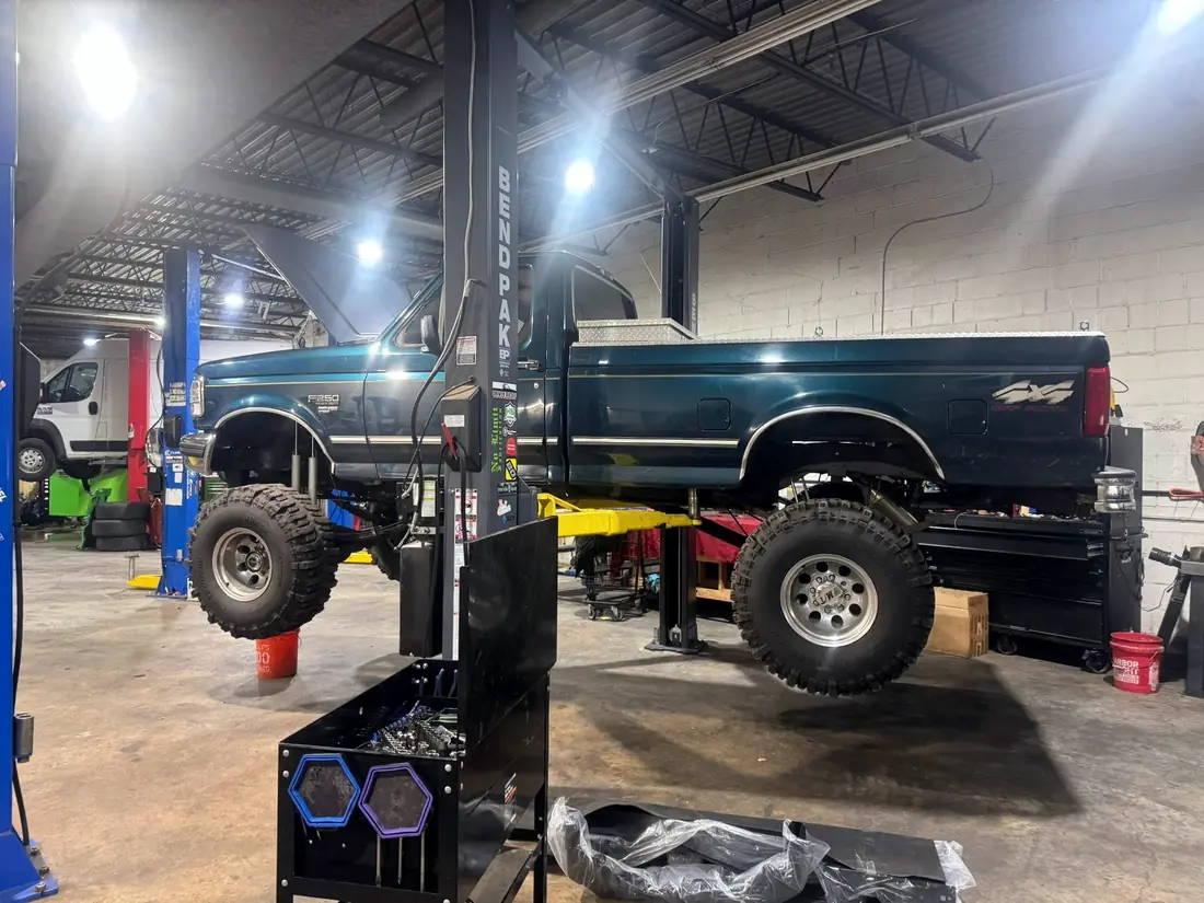 Lifted OBS Ford pickup in the CBS Diesel bay