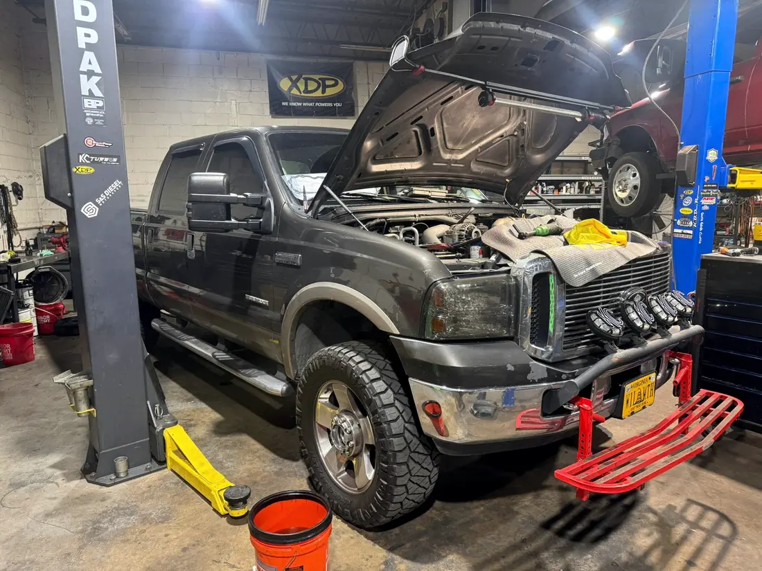Gray Ford F-250 6.0 Power Stroke raised on the lift