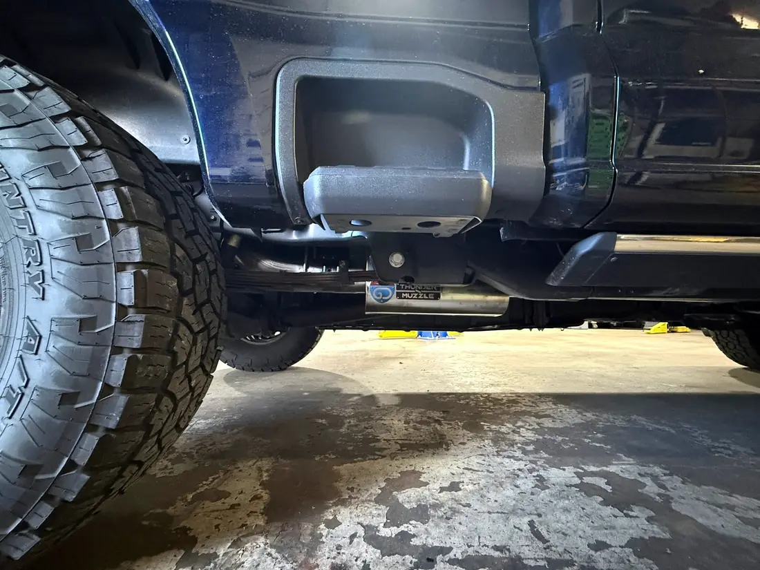Exhaust tip under the bed of a diesel truck