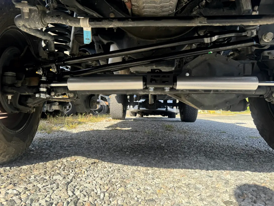 Driveshaft, transfer case and exhaust under a lifted truck