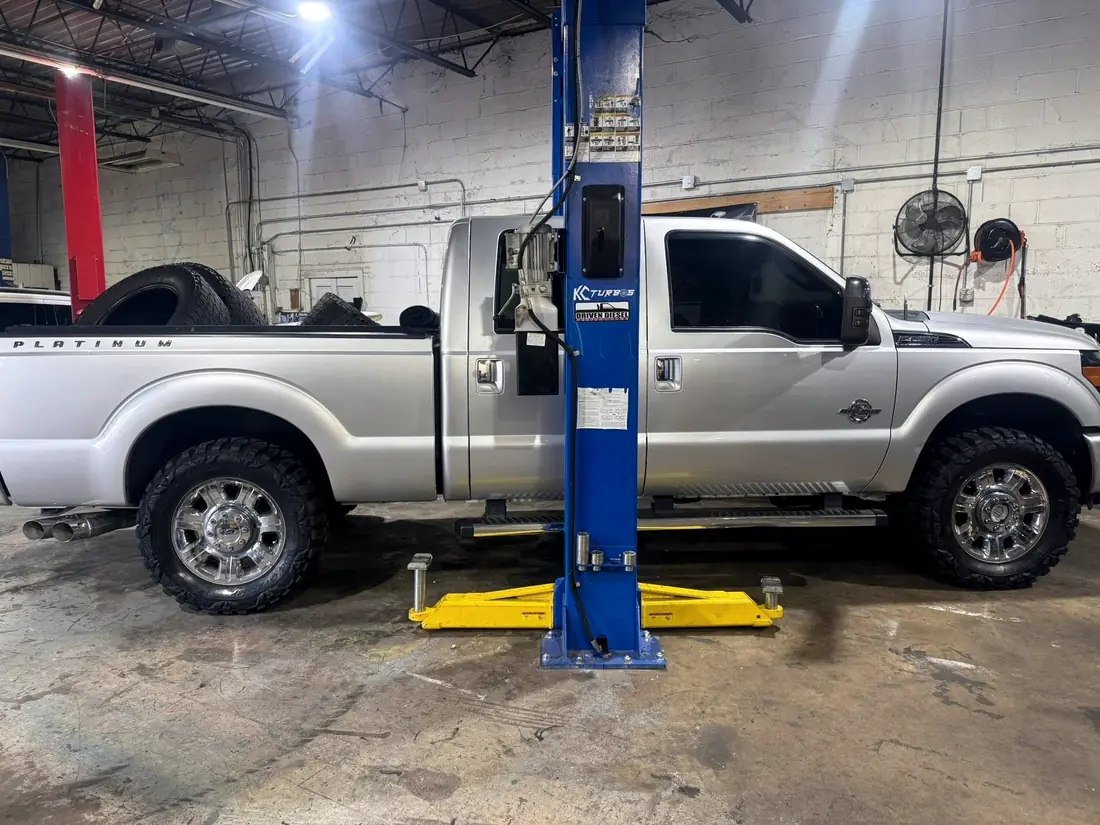 Silver Ford F-250 Platinum on the lift