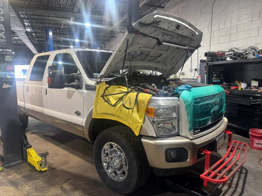White Ford F-250 with fender covers fitted during service