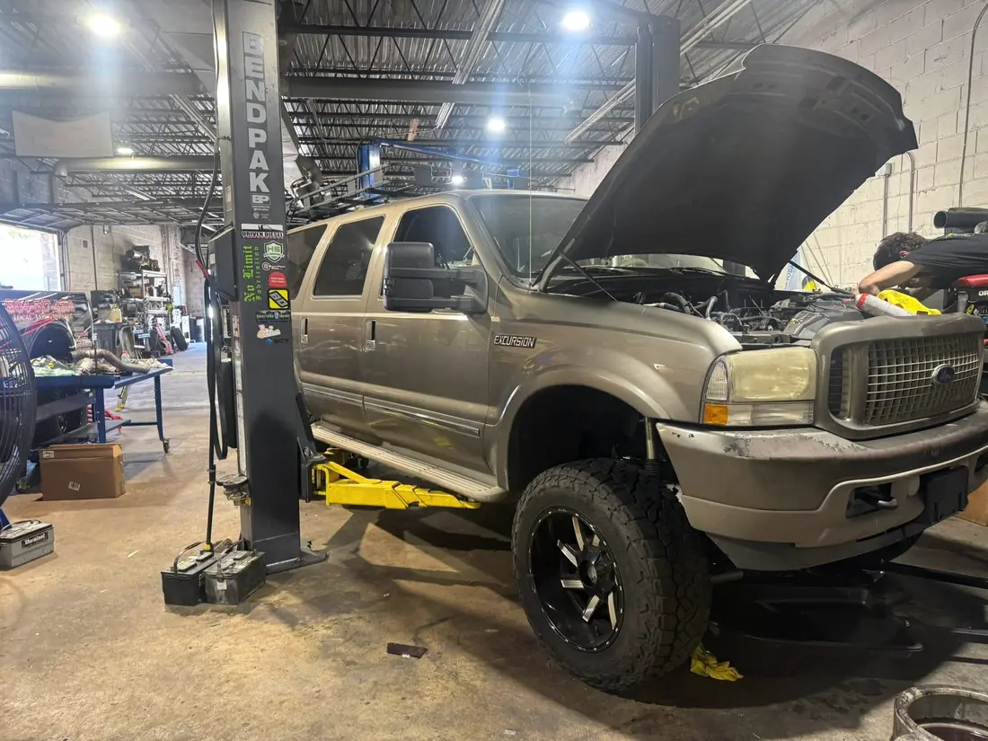 Gold Ford Excursion in the bay at CBS Diesel