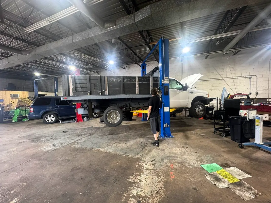 Wide shop view with a flatbed truck in the bay
