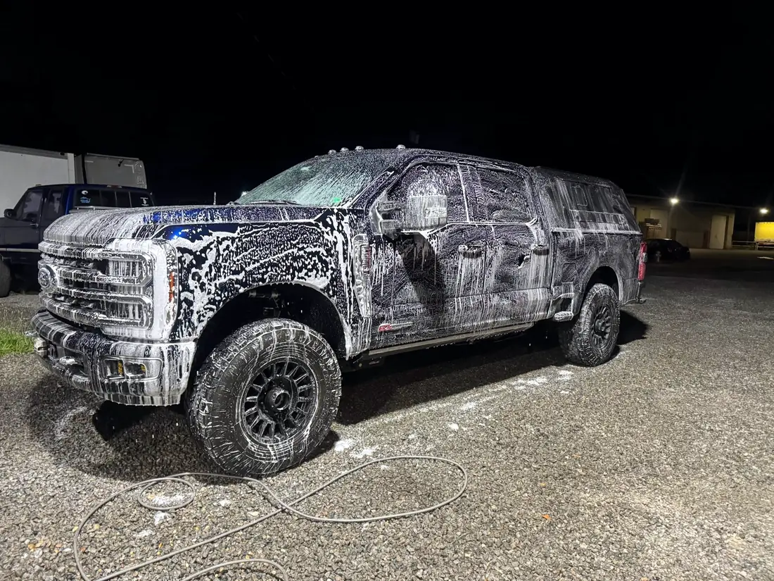 New Ford Super Duty being foam washed outside the shop